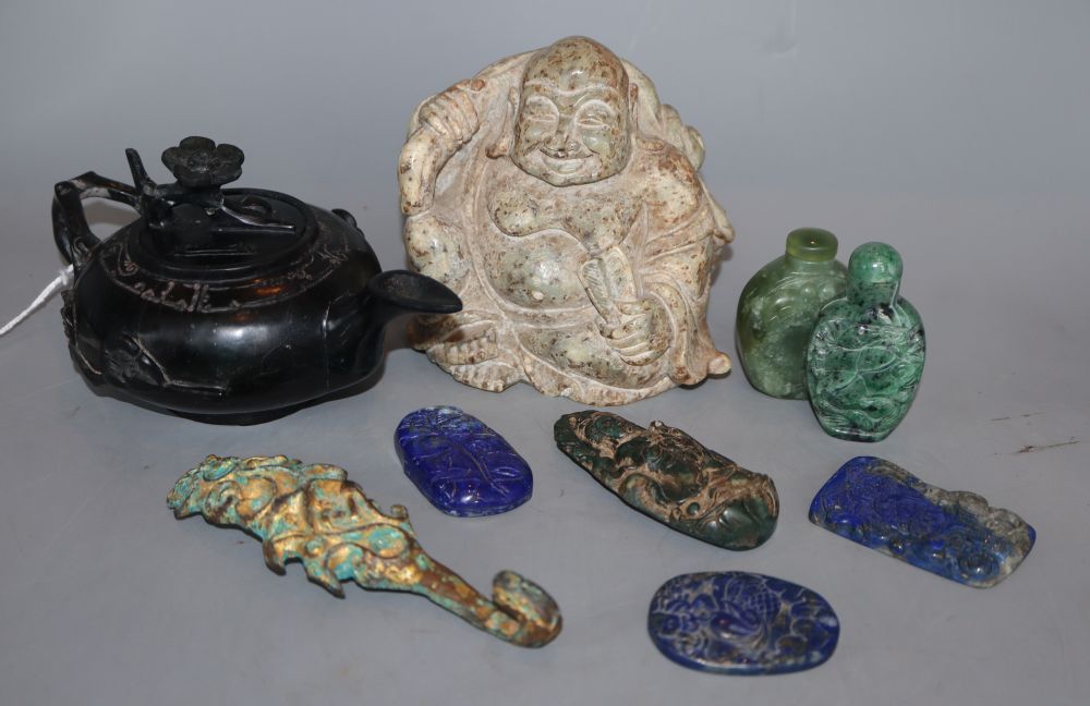 A group of Chinese hardstone carvings, including a Buddha, a lapis lazuli teapot, a belt hook, etc.